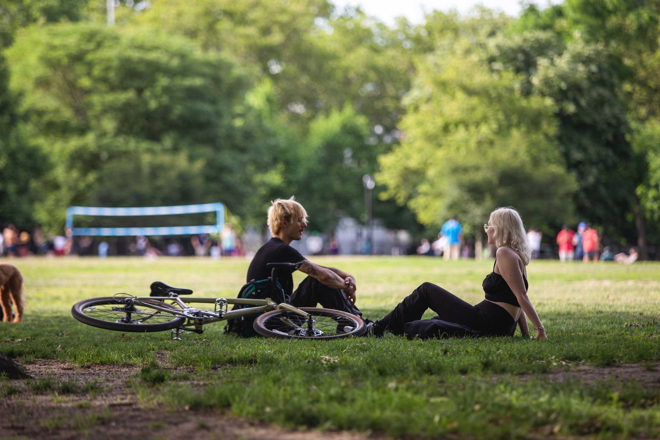 Two people sitting in a Greenpoint park